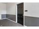 Interior hallway showcasing a dark door with a unit number and gray wainscoting at 12863 Tradd St # 1D, Carmel, IN 46032