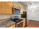 Kitchen featuring stainless steel appliances and granite countertops at 12863 Tradd St # 1D, Carmel, IN 46032