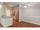 Well-lit kitchen with stainless steel appliances and a breakfast bar adjacent to the dining area at 12863 Tradd St # 1D, Carmel, IN 46032