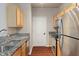 Bright kitchen with stainless steel appliances and light wood cabinetry at 12863 Tradd St # 1D, Carmel, IN 46032