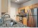 Well-lit kitchen features stainless steel appliances and granite countertops at 12863 Tradd St # 1D, Carmel, IN 46032
