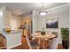 Eat-in kitchen with stainless steel appliances, granite countertops, and a breakfast bar adjacent to a dining area at 12863 Tradd St # 1D, Carmel, IN 46032