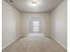 Spacious living room with neutral carpeting and arched doorway at 12863 Tradd St # 1D, Carmel, IN 46032