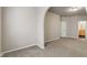 Carpeted living room with neutral walls and arched entrance at 12863 Tradd St # 1D, Carmel, IN 46032