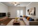 Comfortable living room with wood floors, ceiling fan, and a sliding glass door for lots of natural light at 12863 Tradd St # 1D, Carmel, IN 46032