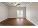 Bright living area with hardwood floors and sliding glass doors to a balcony at 12863 Tradd St # 1D, Carmel, IN 46032