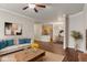 Bright open-plan living room with modern decor adjacent to the kitchen and dining area at 12863 Tradd St # 1D, Carmel, IN 46032