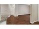 Open-concept living area with dark hardwood floors and a partial view into the kitchen at 12863 Tradd St # 1D, Carmel, IN 46032