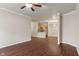 Open-concept living area with hardwood floors flowing into a kitchen space at 12863 Tradd St # 1D, Carmel, IN 46032