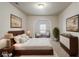 Spacious main bedroom with a sitting area, archway, and stylish decor at 12863 Tradd St # 1D, Carmel, IN 46032