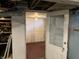 Unfinished basement with an open doorway, a painted floor, and a utility-focused space at 2025 Main St, Elwood, IN 46036