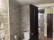 Hall bathroom with white toilet and brick wall features at 2025 Main St, Elwood, IN 46036