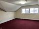 Bedroom featuring red carpet, neutral walls, and a bright window at 2025 Main St, Elwood, IN 46036