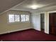 Spacious bedroom featuring red carpet, neutral walls, closet and windows at 2025 Main St, Elwood, IN 46036