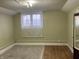 Bright bedroom featuring a window with natural light, carpet, and a neutral color palette at 2025 Main St, Elwood, IN 46036