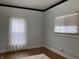 Bedroom with a large window, hardwood floors, and neutral-colored walls and trim at 2025 Main St, Elwood, IN 46036
