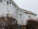 Side entrance of home featuring vinyl siding, grey door and trim at 2025 Main St, Elwood, IN 46036