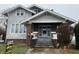 Charming two-story home featuring a covered front porch with brick accents and well-maintained landscaping at 2025 Main St, Elwood, IN 46036
