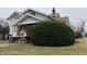 Two-story home with brick accents, covered front porch, and a neatly landscaped yard at 2025 Main St, Elwood, IN 46036