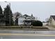Two-story home with brick accents, covered front porch, and a neatly landscaped yard at 2025 Main St, Elwood, IN 46036