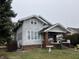 Charming two-story home featuring a covered front porch and well-maintained landscaping at 2025 Main St, Elwood, IN 46036