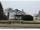 Two-story home with brick accents, covered front porch, and a neatly landscaped yard at 2025 Main St, Elwood, IN 46036