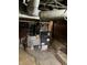 Close-up of a Goodman furnace in a basement with a dark ceiling and concrete floor at 2025 Main St, Elwood, IN 46036