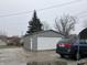 Detached two-car garage with a side entrance and driveway at 2025 Main St, Elwood, IN 46036