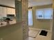 View of kitchen with brick divider to dining area at 2025 Main St, Elwood, IN 46036
