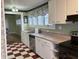 Kitchen sink and counter area with white cabinets and checkered floor at 2025 Main St, Elwood, IN 46036