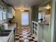 View of a kitchen with white cabinets and a red and white checkered floor at 2025 Main St, Elwood, IN 46036