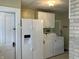 Laundry room with white washer and dryer, and white refrigerator at 2025 Main St, Elwood, IN 46036
