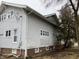 Side view of a well-maintained two-story home with a tree-lined yard at 2025 Main St, Elwood, IN 46036