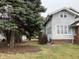 Side view of a well-maintained two-story home with a tree-lined yard at 2025 Main St, Elwood, IN 46036