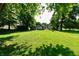 A spacious backyard with lush grass, mature trees, and ample space for outdoor activities at 2850 Tansel Rd, Indianapolis, IN 46234