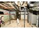 Unfinished basement showing concrete walls and floor with utilities and low ceilings at 2850 Tansel Rd, Indianapolis, IN 46234