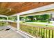 Inviting covered front porch with wood railing, offering a relaxing outdoor space with neighborhood views at 2850 Tansel Rd, Indianapolis, IN 46234