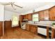 A cozy kitchen with wood cabinets, and a window to view the outdoors when washing dishes at 2850 Tansel Rd, Indianapolis, IN 46234