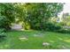 Large backyard with mature trees and a detached two-car garage, offering ample space for outdoor activities at 3543 N Kenwood Ave, Indianapolis, IN 46208