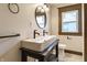 Bathroom featuring double sinks, modern lighting and fixtures and a window at 3543 N Kenwood Ave, Indianapolis, IN 46208