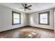 The bedroom has wood-look floors, a ceiling fan and two windows at 3543 N Kenwood Ave, Indianapolis, IN 46208
