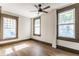 The bedroom features wood-look floors and three windows at 3543 N Kenwood Ave, Indianapolis, IN 46208