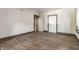 Cozy bedroom featuring neutral paint and new hardwood floors with a closet and 2 doors at 3543 N Kenwood Ave, Indianapolis, IN 46208