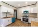 Updated kitchen with white cabinets, stainless steel appliances and a breakfast bar at 3543 N Kenwood Ave, Indianapolis, IN 46208