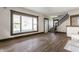 Bright living room featuring new floors, neutral paint, and an open staircase at 3543 N Kenwood Ave, Indianapolis, IN 46208