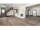 Spacious living room with staircase, neutral paint, updated floors, and a decorative fireplace at 3543 N Kenwood Ave, Indianapolis, IN 46208