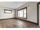 Bright living room featuring new floors, neutral paint, and large windows providing ample natural light at 3543 N Kenwood Ave, Indianapolis, IN 46208