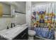 This bathroom features grey wallpaper, marble sink and Paw Patrol themed shower curtain at 3807 S Olney St, Indianapolis, IN 46237
