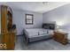 Cozy bedroom with carpet flooring, a window, and classic furnishings, offering a relaxing and comfortable space at 3807 S Olney St, Indianapolis, IN 46237