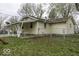 View of the back of this property featuring a covered patio and fenced backyard at 3807 S Olney St, Indianapolis, IN 46237